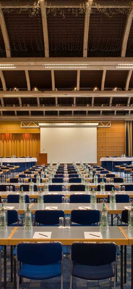 The Rhein-Lahn Saal conference room is set up with rows of tables and chairs, ready for a large meeting or event.