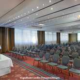 A spacious conference room with rows of empty chairs is prepared for an upcoming event at Wyndham Garden Donaueschingen.