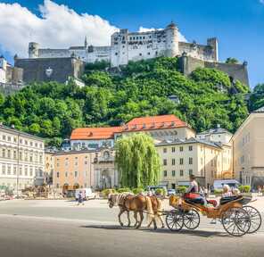 View of the culture city Salzburg with a castle and horse-drawn carriage