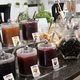 An array of assorted jams and dried fruits is elegantly displayed on a breakfast buffet, inviting a tasty morning treat.