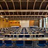 The Rhein-Lahn Saal conference room is set up with rows of tables and chairs, ready for a large meeting or event.