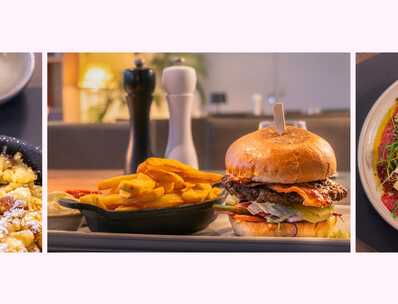 A delicious spread features fluffy pancakes with berry sauce, a gourmet burger with fries, and a vibrant carpaccio salad.