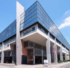 The modern Radisson Blu building showcases extensive glass façades and stylish architectural design.